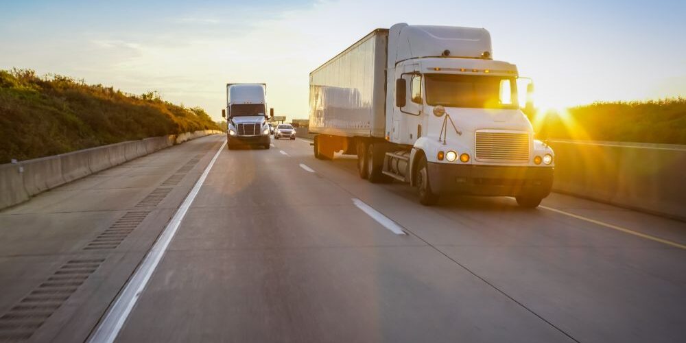 Semi truck on highway at sunset